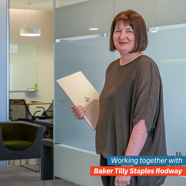 Fiona from Baker Tilly walking in a hallway