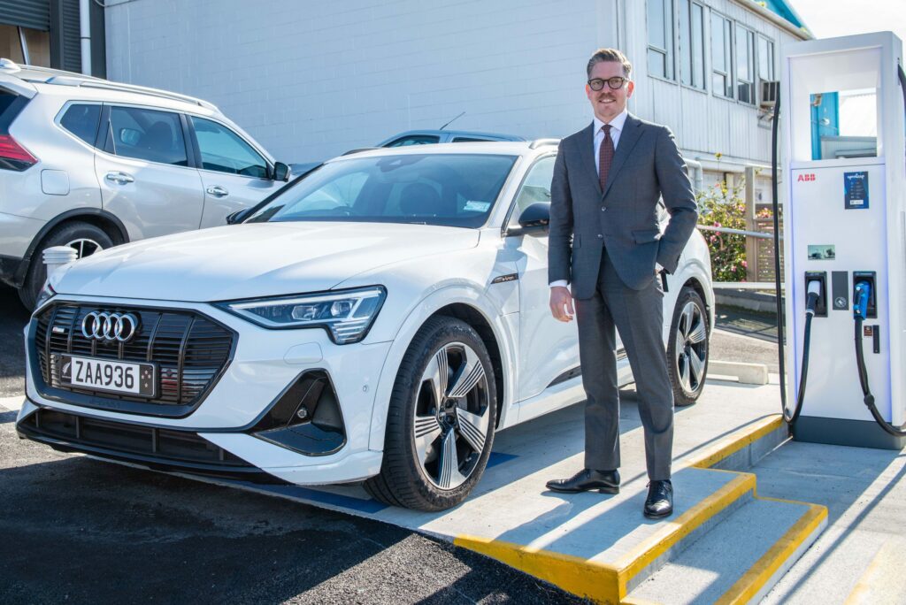 Blair Woolford standing in front of an electric charger